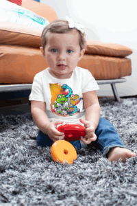 Toddler wearing white custom jersey shirt from NoaWear